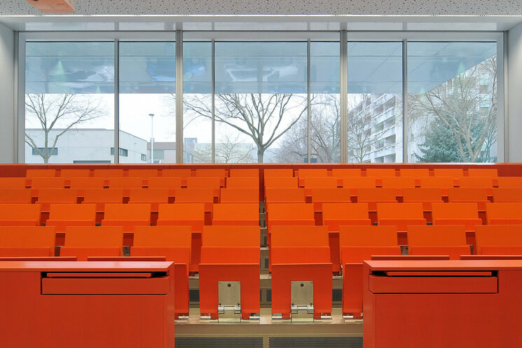 Hörsaal in orangenen Stühlen